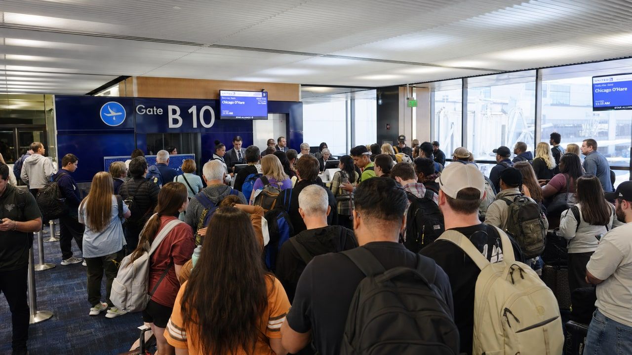 Crowded airport gate area with passengers waiting to board a full flight